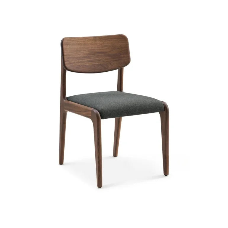 Angled view of Aurelia Dining Chair highlighting curved wooden backrest and upholstered seating