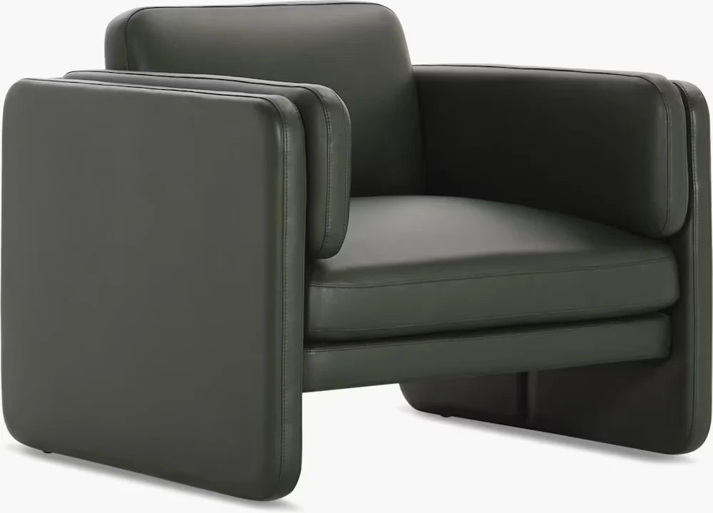 Side view of Aveline Armchair with curved silhouette and thick cushioned seating for comfort