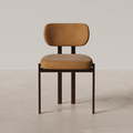Coral Dining Chair featuring slim brown legs and cushioned upholstered seat