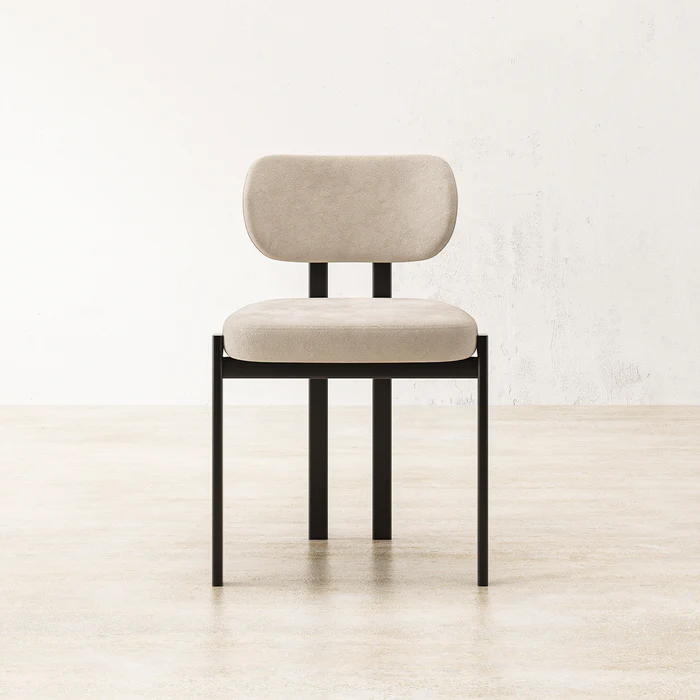 Coral Dining Chair featuring slim black legs and white cushioned upholstered seat