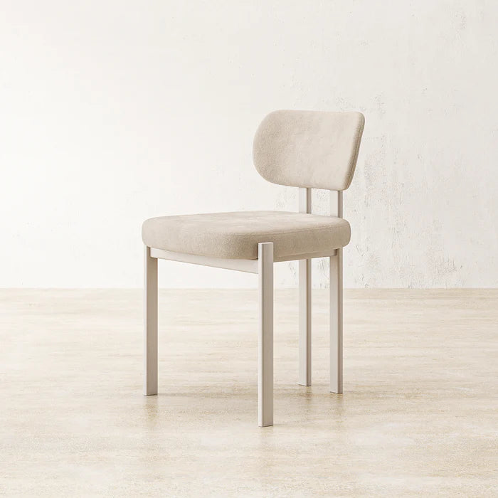 Side view of Coral Dining Chair with slender white legs and ergonomic cushioned seating