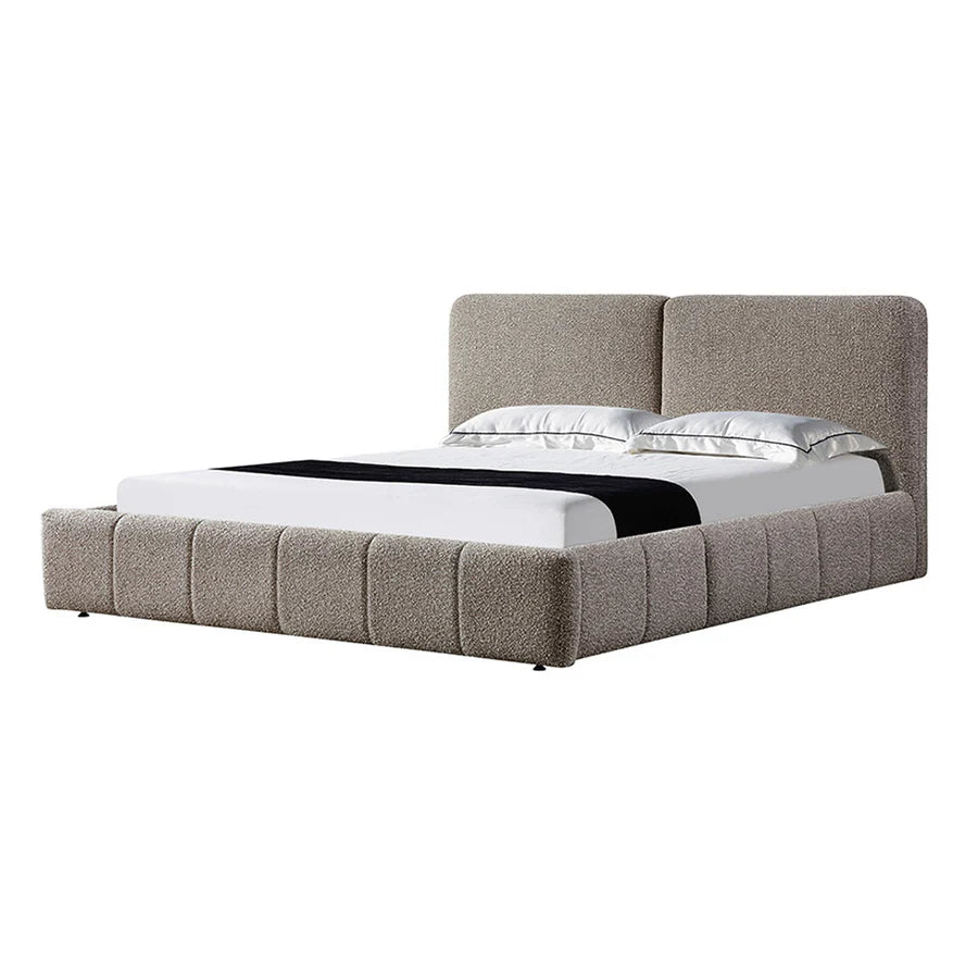 Angled view of the Critter Bed highlighting its curved split headboard and textured boucle finish