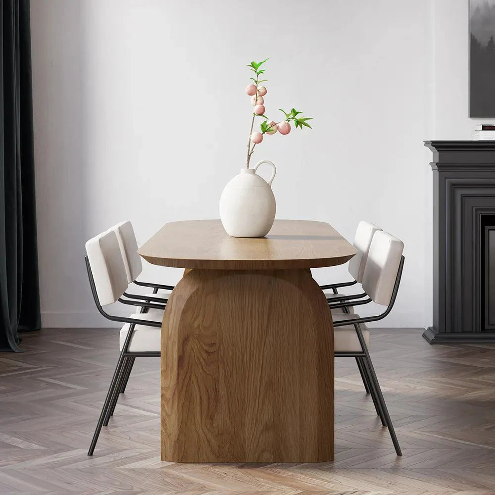 Deer Oval Dining Table in a contemporary UAE dining room with walnut color wood top and sculpted double-pillar base