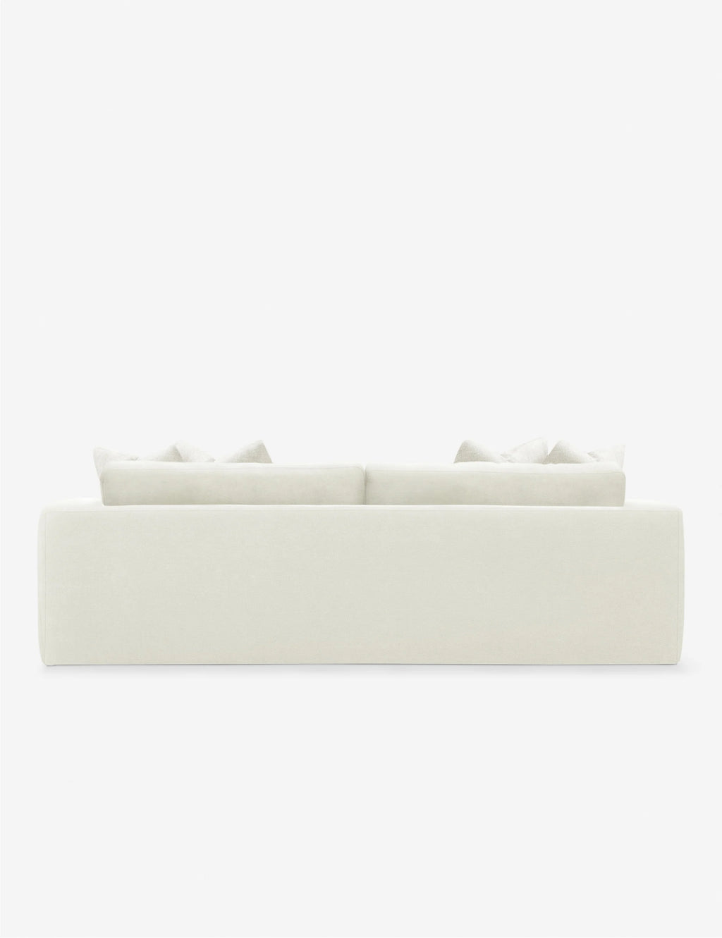Back View of Gunhee Sofa styled with earthy decor and layered textiles