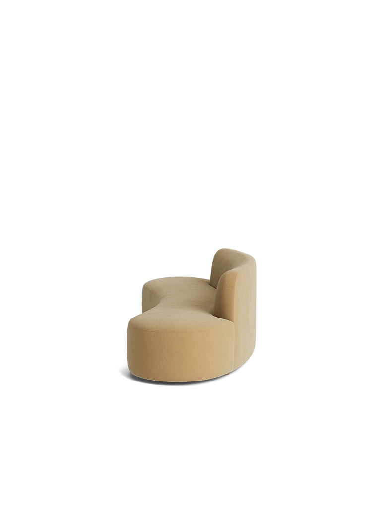 side view of the Haein Sofa brie fabric highlighting its sculptural form and deep, cushioned seat.