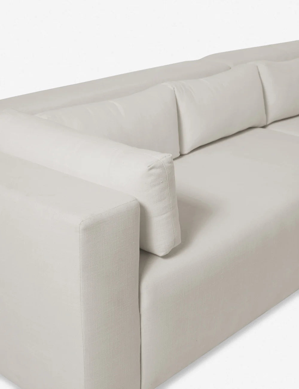 Side profile of Jinah Sofa highlighting the blocky silhouette and cushioned armrest design
