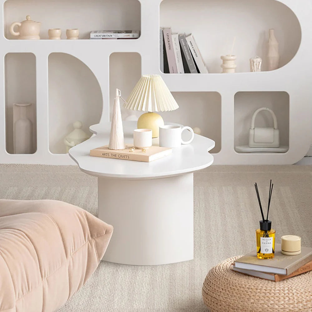 Legia dining table in white with organic top and sculptural base SIde View in Living room setting