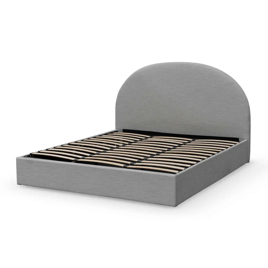 side view of gray Marinca Bed highlighting its sculpted half-moon headboard and frame