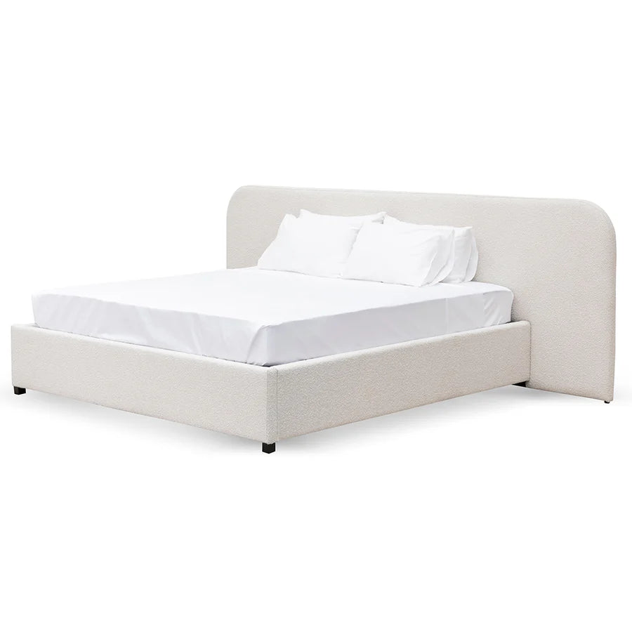 Side view of Miso Bed with black matte legs, sleek base, and textured bouclé upholstery