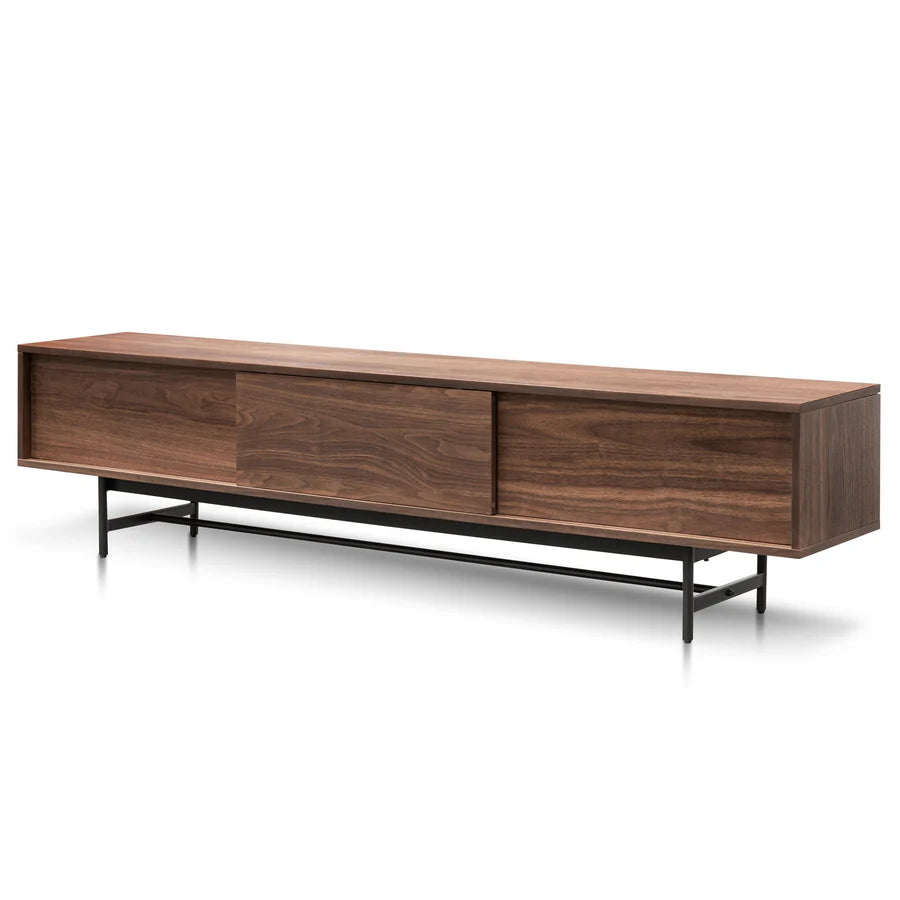 Angled view of Orcas Walnut Media Unit highlighting sliding doors, open shelves, and sleek low-profile design