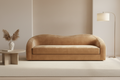 Camel Vintage Velvet sofa in a minimalistic room with a lamp and decorative vase.