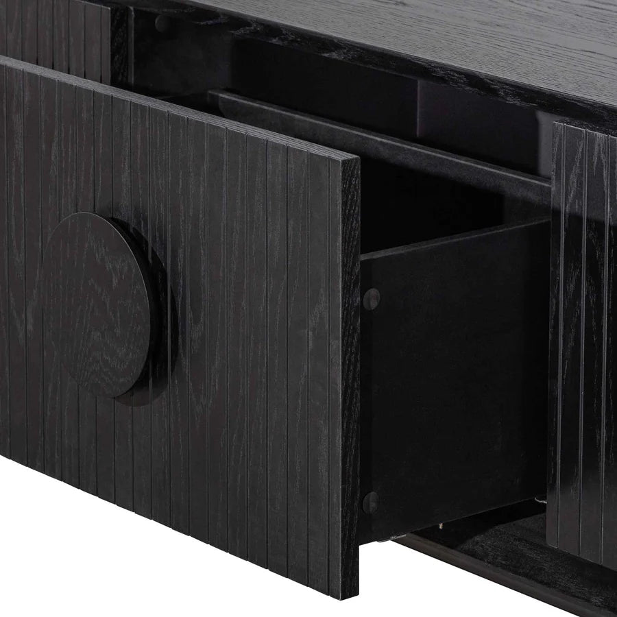 Detailed close-up of Sylph Console Table’s modern black strips and circled wooden drawer handles 