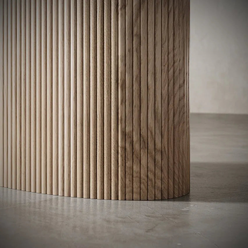 Detailed close-up of Vangeance Dining Table’s natural wood texture and seamless base construction