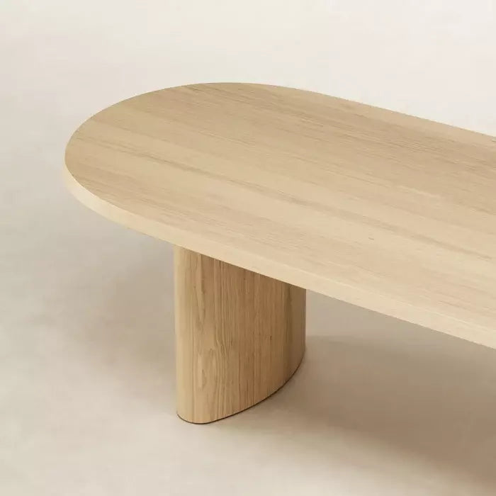 Detailed close-up of Natural color Zora Ideale Dining Table’s solid ash wood texture and curved leg craftsmanship