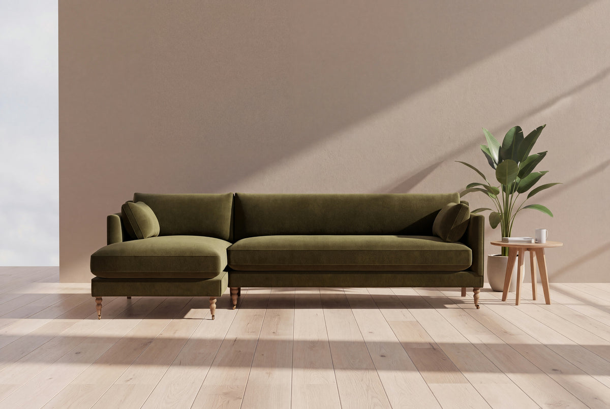 Lennart sectional sofa in olive velvet in a sunlit living room with oak floor