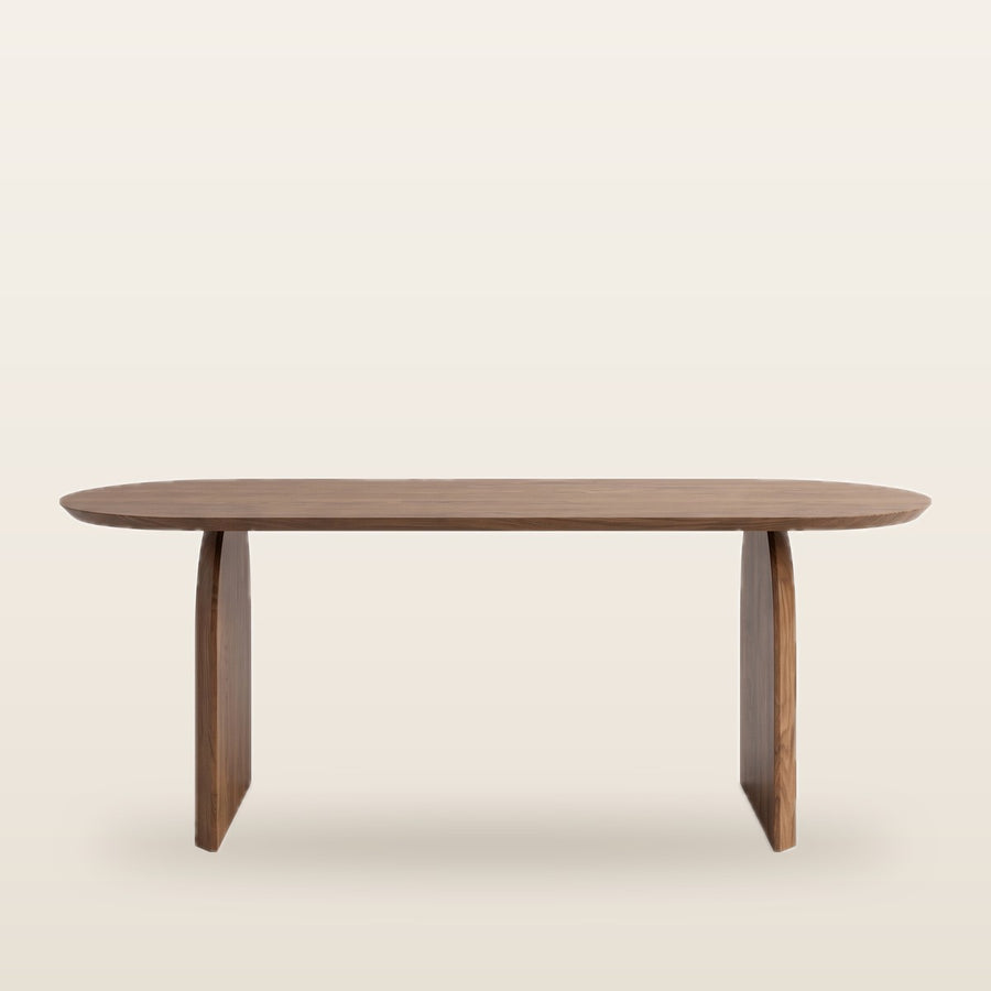 Deer Oval Dining Table in a contemporary UAE dining room with natural cherry wood color top and sculpted double-pillar base