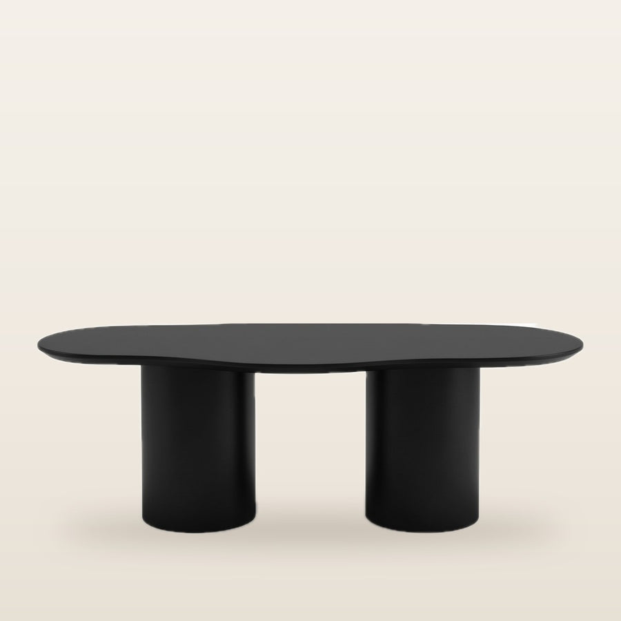 Legia dining table in black with organic top and sculptural base top SIde View in Living room setting
