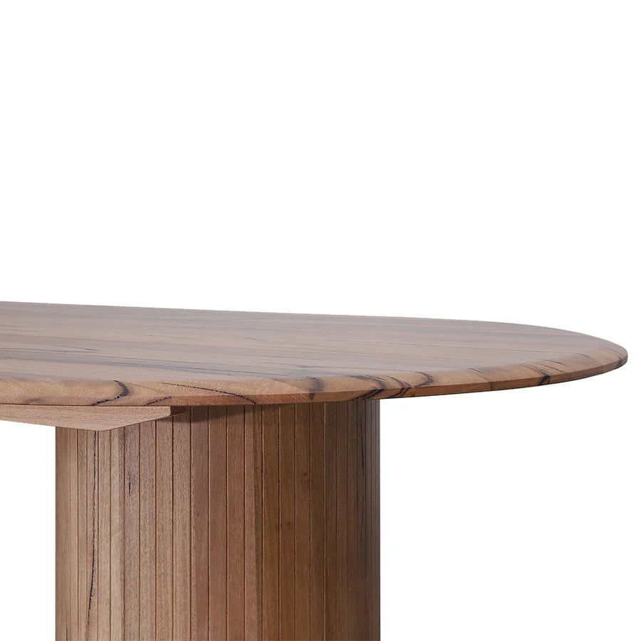 Azura capsule-shaped dining table with solid wood finish and rounded edges close up