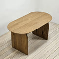 Henry capsule dining table with solid wood construction and curved panel legs