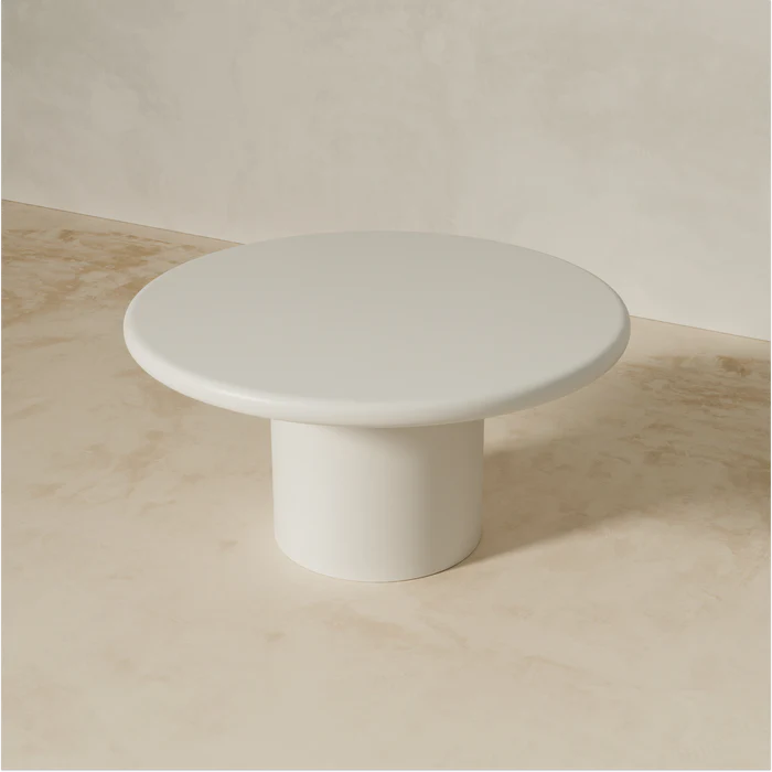 Angled view of Liebe dining table showing soft edge and sculptural base design