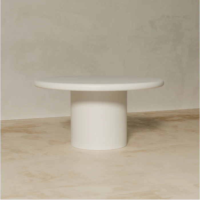 Liebe round dining table with cylindrical pedestal base in matte off-white finish
