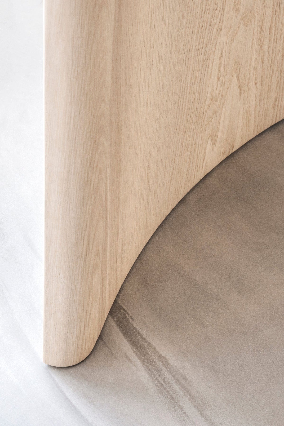 Close leg view of Dew Dining Table showing matte oak finish